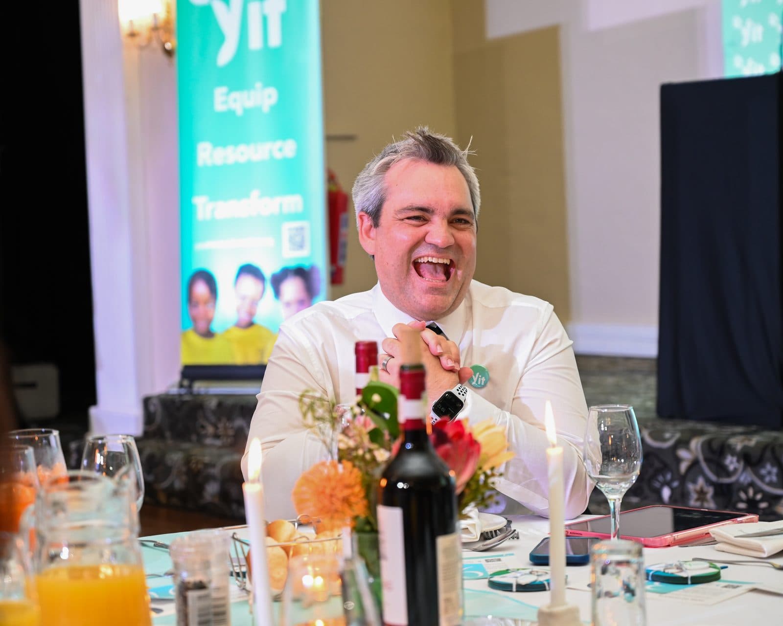 A guest laughing at the YIT Gala dinner table